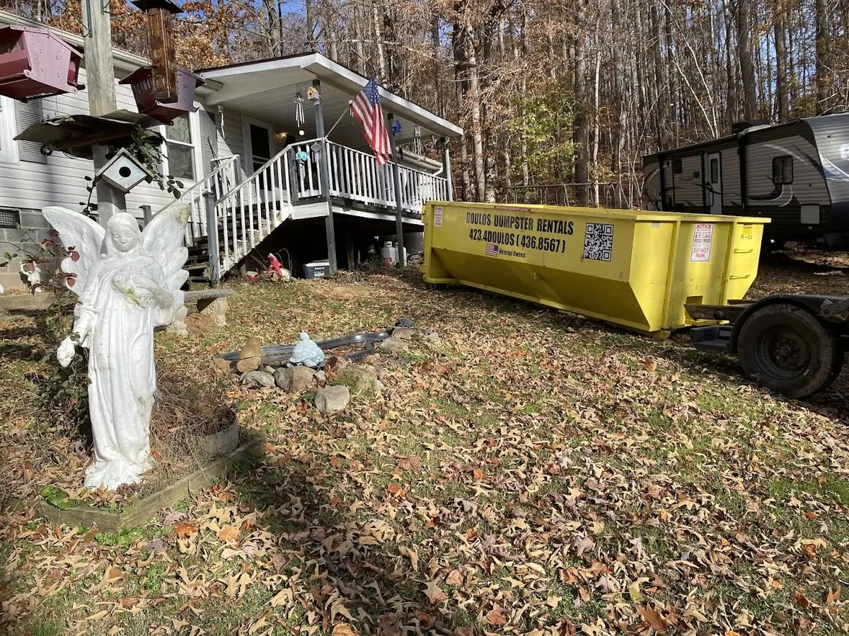 15 yard dumpster on a residential driveway during a yard cleanup