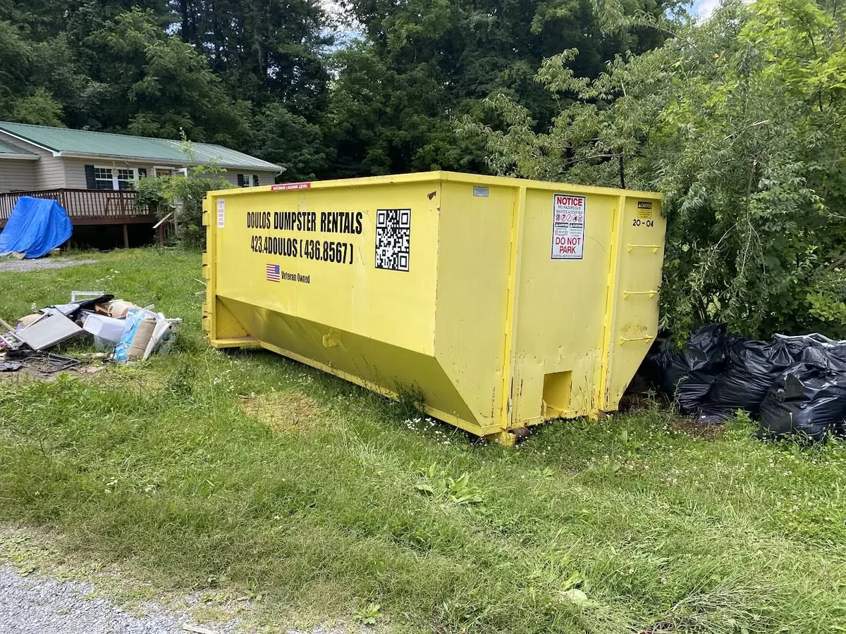 20 yard dumpster on a driveway during a household cleanout
