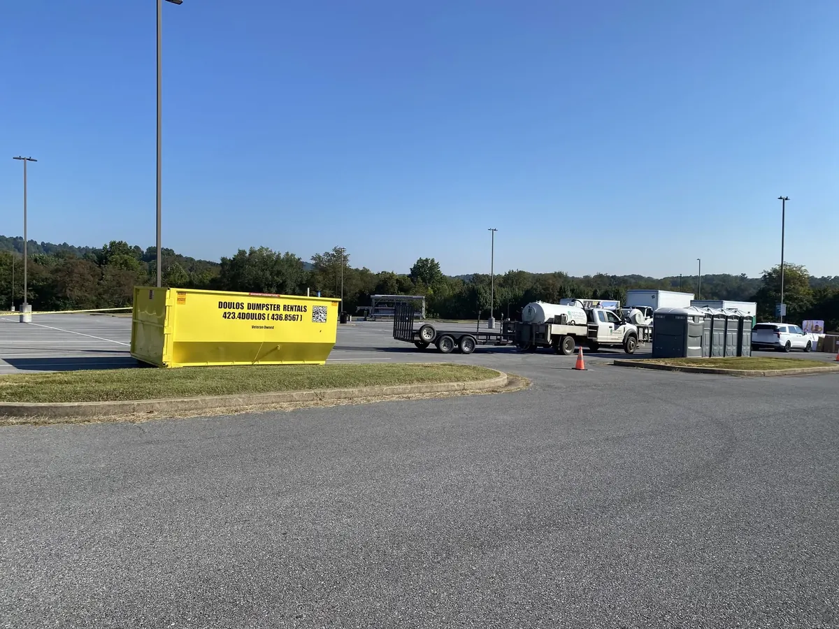 Dumpster in a commercial parking lot for a contractor