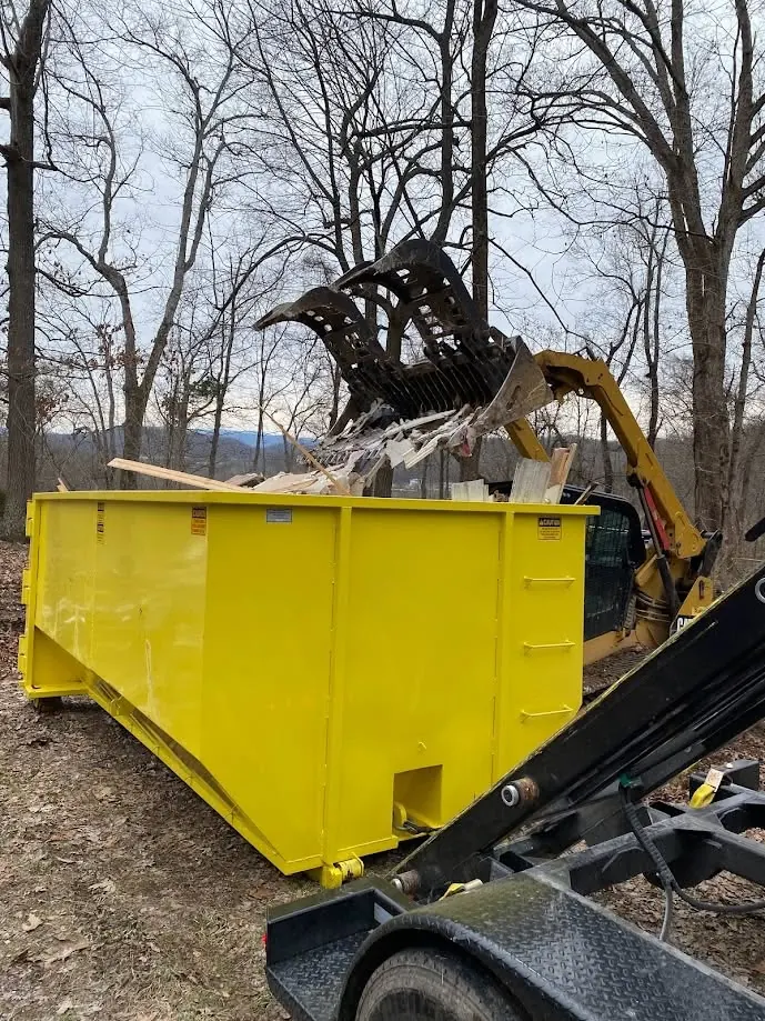 Dumpster being loaded with demolition debris