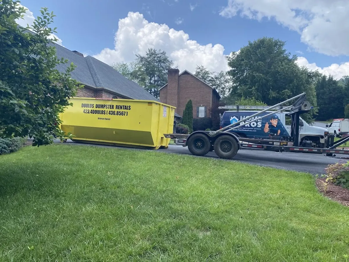 Dumpster in a driveway during a home improvement project