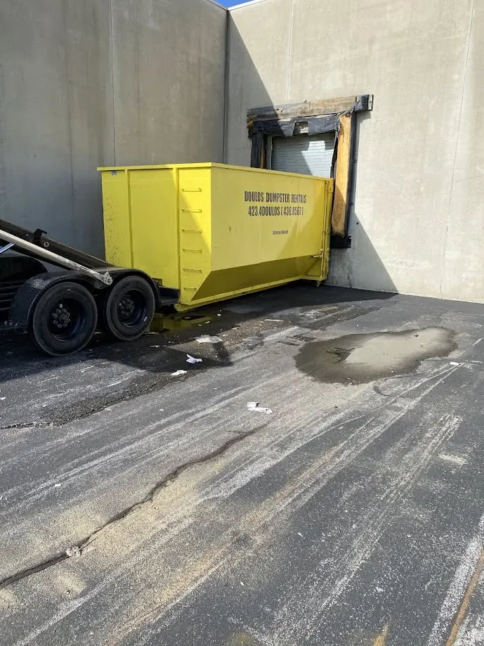 Dumpster positioned at a loading dock