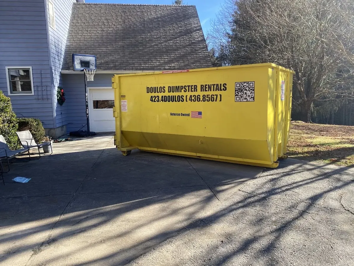 25 yard dumpster on a driveway in winter