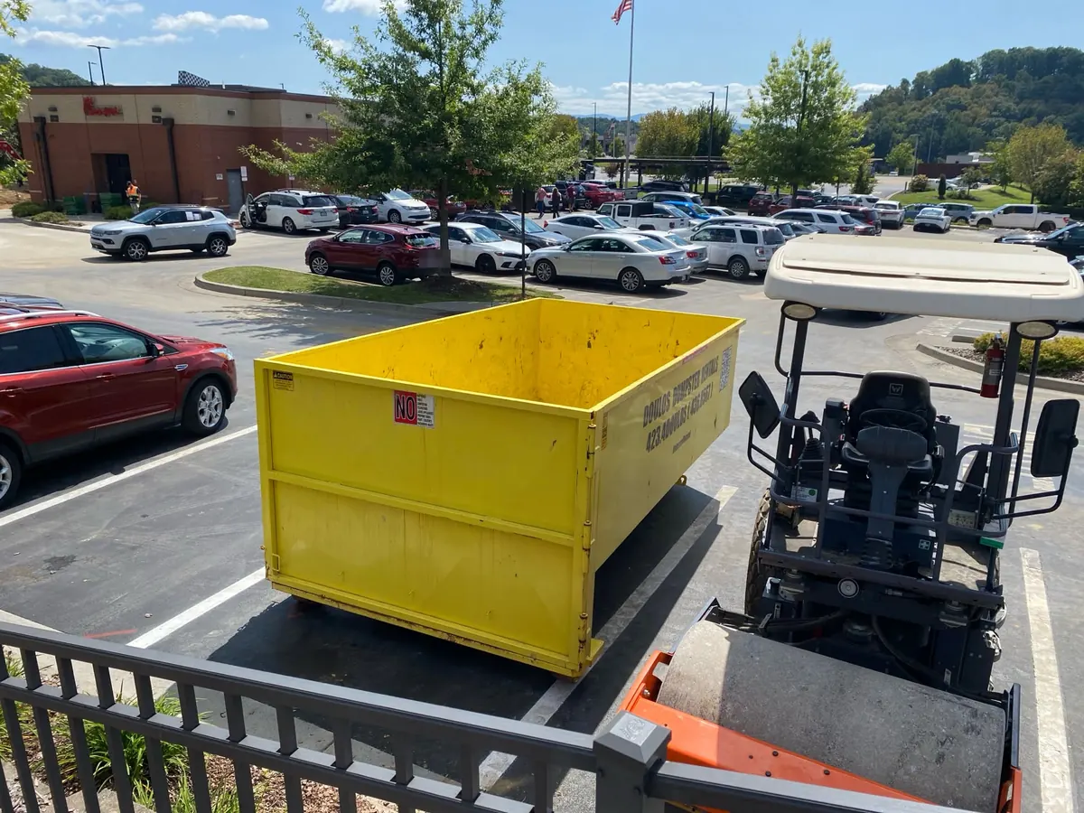 Dumpster at a shopping center during a property cleanout